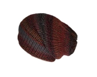 May include: A knit beanie featuring a variegated color pattern with blended shades of deep red, dark brown, and charcoal gray. The hat is constructed with a ribbed texture throughout, showcasing a soft, rounded silhouette and a folded brim edge.