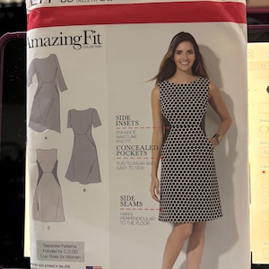 May include: Simplicity Amazing Fit dress pattern. The pattern features a woman in a black and white polka dot dress. The pattern includes side insets, concealed pockets, and side seams. Size U.S. 20W-28W.