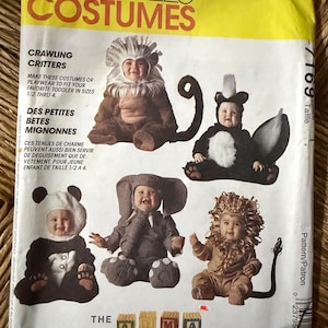 May include: A McCall's Costumes sewing pattern envelope for toddler crawling critter costumes in sizes 1/2 through 4. The front features illustrations of five children wearing animal costumes including a monkey, skunk, panda, elephant, and lion.
