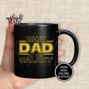 May include: Black coffee mug with a yellow graphic that says "Best Dad in the Galaxy".