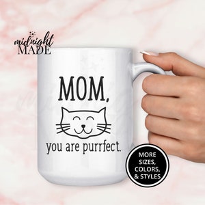 May include: White ceramic coffee mug with a black cat illustration and the text "MOM. you are purrfect."
