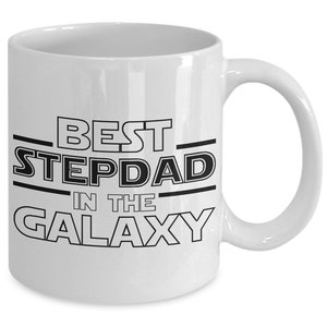May include: White ceramic coffee mug with black text that reads "Best Stepdad in the Galaxy".