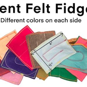 May include: A set of eight felt fidgets in various colors, each with a different design. The fidgets are 6 inches long and 4 1/2 inches wide.  The text "Silent Felt Fidgets" and "Different colors on each side" is visible at the top of the image.