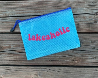 May include: A light blue mesh zippered pouch with a blue zipper pull and the word "lakeholic" printed in pink.