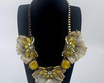 Collar babero floral vintage en tono dorado con piedras llamativas de color amarillo iridiscente.