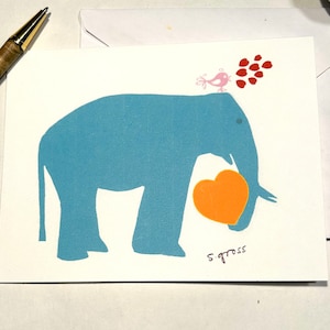 May include: A blue elephant silhouette holding a large orange heart. A small pink bird with red hearts above it. The artist's signature, "S. Gross", is in the bottom right corner.