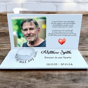 May include: White memorial candle holder with a photo of a man and a poem. The holder has a space for a tea light candle and the text "Matthew Smith, Forever in our hearts, 19.11.55 - 30.11.24".