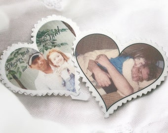 May include: Two heart-shaped photo keepsakes with white borders. One features a photo of a man and a girl with the text "There's with me" and the other features a photo of a man with the text "Dad".
