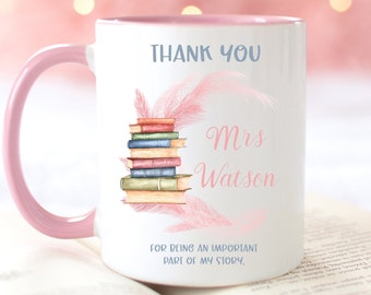 May include: Pink and white coffee mug with a pink rim. The mug has a stack of books, pink feathers, and the text "Thank You Mrs. Watson For being an important part of my story."