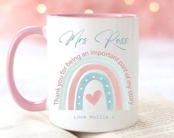May include: A white ceramic mug with a pink rim and handle. The mug has a rainbow design with a pink heart in the center. The text "Mrs Ross Thank you for being an important part of my story Love Hollie x" is printed on the mug.