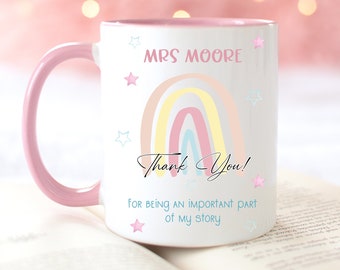May include: Pink and white ceramic mug with a rainbow and stars design. The mug says "Mrs. Moore" and "Thank You! For being an important part of my story."