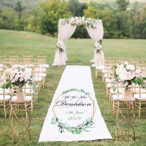 May include: White wedding aisle runner with a gold geometric frame and green foliage design. The text reads "Mr. & Mrs. Dennison 12th June 2019".