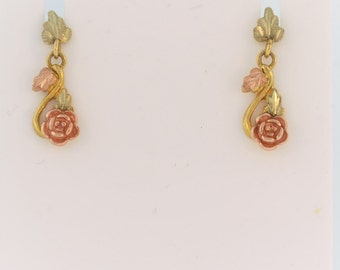 May include: A pair of gold, green, and rose gold earrings featuring a rose and leaf design.