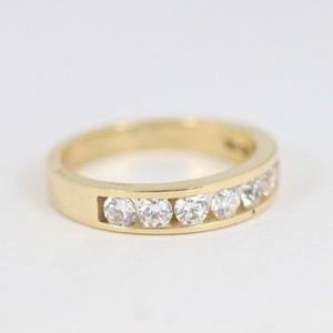 Channel Set Cubic Zirconia Wedding Band In 14K Yellow Gold