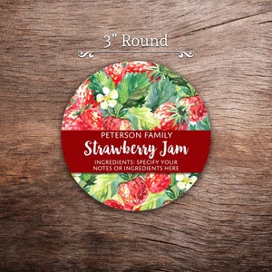 May include: A 3-inch round label with a watercolor illustration of strawberries and leaves. The label is red and has the text "PETERSON FAMILY Strawberry Jam" and "INGREDIENTS: SPECIFY YOUR NOTES OR INGREDIENTS HERE".