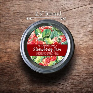 May include: A 2.5 inch round jar lid label with a watercolor illustration of strawberries and green leaves. The label is red and white with the text "PETERSON FAMILY Strawberry Jam INGREDIENTS: SPECIFY YOUR NOTES OR INGREDIENTS HERE".