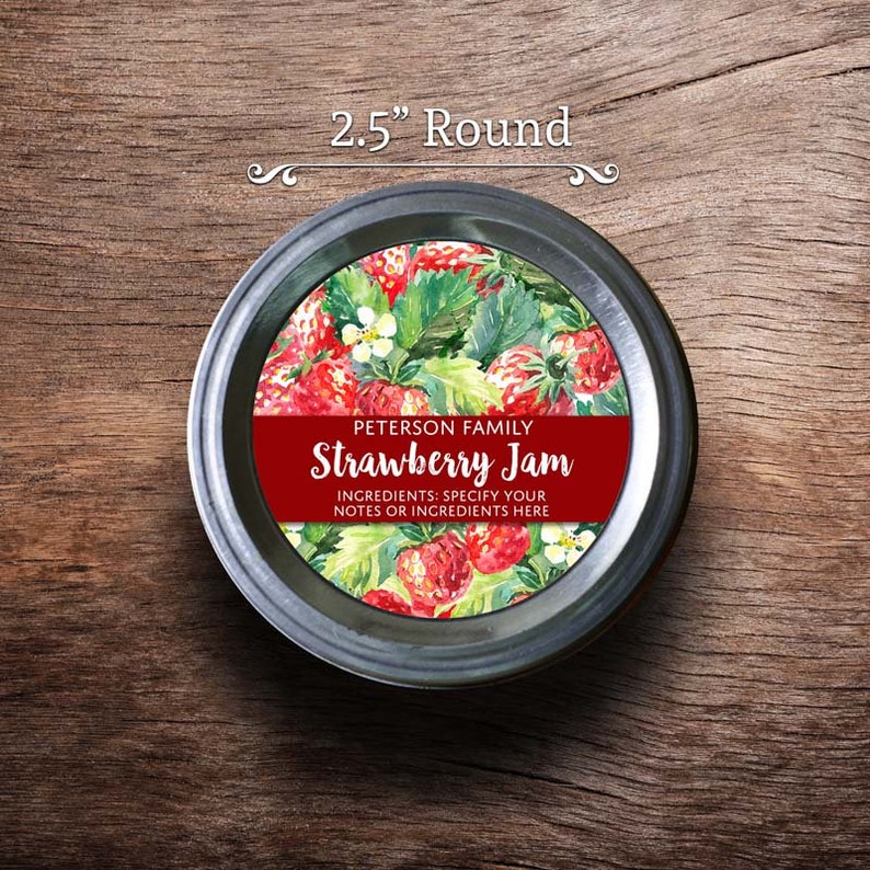 May include: A 2.5 inch round jar lid label with a watercolor illustration of strawberries and green leaves. The label is red and white with the text "PETERSON FAMILY Strawberry Jam INGREDIENTS: SPECIFY YOUR NOTES OR INGREDIENTS HERE".