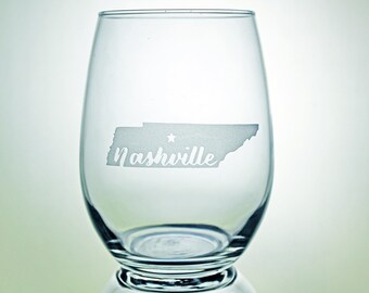 May include: A clear glass wine glass with an etched design of the state of Tennessee and the word "Nashville".
