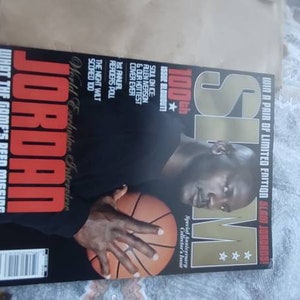 May include: A magazine cover featuring Michael Jordan holding a basketball. The cover has the text "JORDAN" in large red letters, with the headline "WHAT THE GAME'S BEEN MISSING." The magazine is a limited edition.