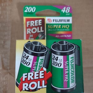 May include: Three rolls of Fujifilm Super HQ 35mm film for color prints. The film packaging is green, yellow, and red, with the words "FREE ROLL" and "200 SPEED" printed on the boxes. The film is designed for all-around use.