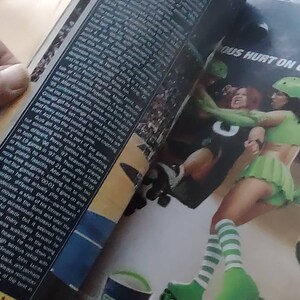 May include: An open magazine with a roller derby theme. The pages show action shots of roller derby athletes in green and white uniforms, roller skates, and a Right Guard product. Text includes "INYOURFACE" and "Xtreme Right Guard."