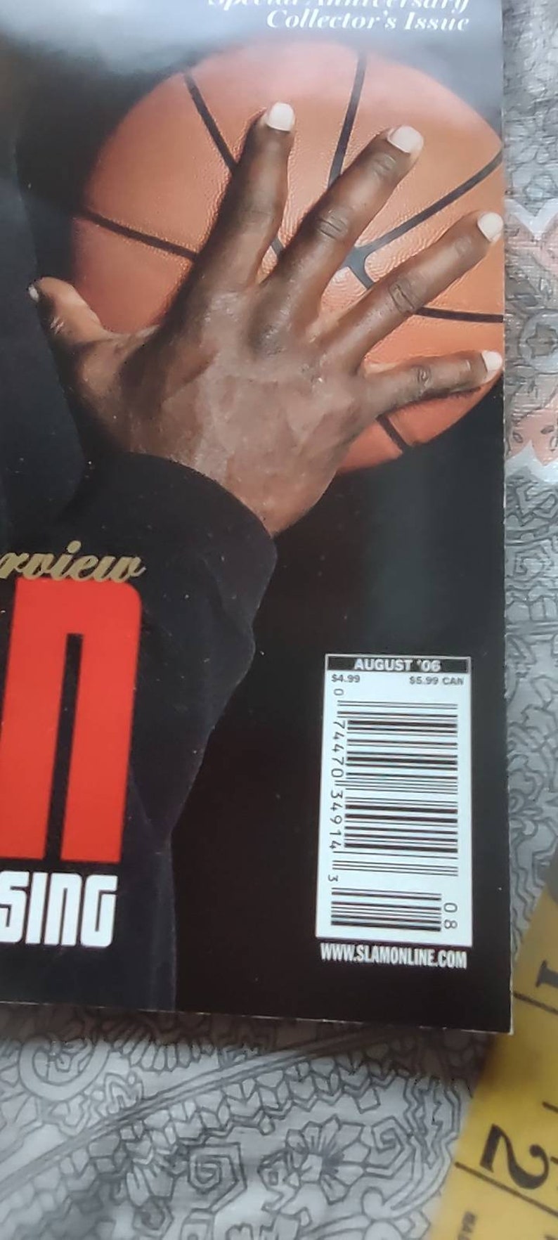 May include: A magazine cover featuring a basketball and a hand reaching towards it. The cover includes the text "Special Anniversary Collector's Issue" and "August '06". The magazine also has a barcode and the website address www.slamonline.com.