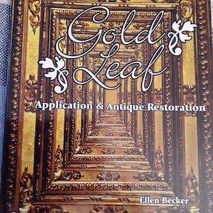 May include: A book titled "Gold Leaf: Application & Antique Restoration" by Ellen Becker. It is a Schiffer Book for Woodworkers and features a gold-leafed frame on the cover.