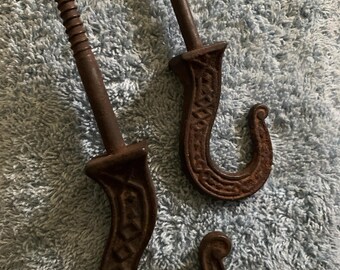 Two Victorian Iron Hooks with Identical design, 7 inches and 5 inches long with screw in bottoms.