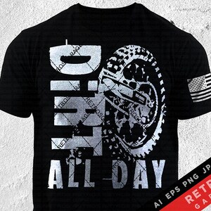 May include: A black t-shirt with a white graphic design of a dirt bike and the words "Dirt All Day". The design is distressed and has a vintage look. The shirt also features a small American flag on the right sleeve.