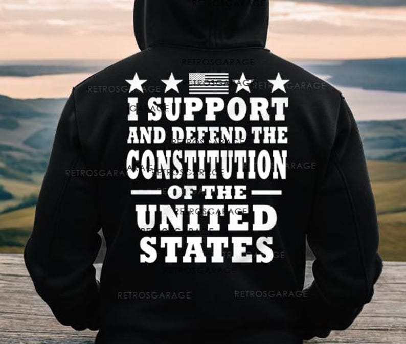 May include: Black hooded sweatshirt with white text that reads "I support and defend the Constitution of the United States". The text is surrounded by four stars and a small American flag.