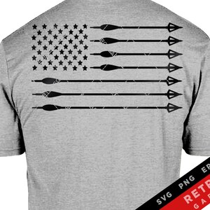 May include: A gray t-shirt with a black and white American flag design featuring arrows pointing to the right. The flag is distressed and has a vintage look. The text "SVG PNG EPS AI RETROS GARAGE" is in the bottom right corner.