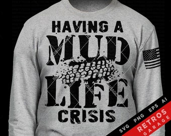 May include: A gray long-sleeve shirt with a black graphic that reads "Having a Mud Life Crisis". The graphic features a tire track print. The shirt also has a small American flag on the right sleeve. The text "SVG PNG EPS AI RETROS GARAGE" is at the bottom right corner of the image.