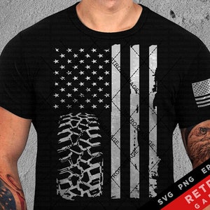 May include: A black t-shirt with a distressed American flag design featuring a tyre tread print. The flag is in shades of grey and white. The text "RETR0S GARAGE" is in white with a black outline and the text "SVG PNG EPS AI" is in white.