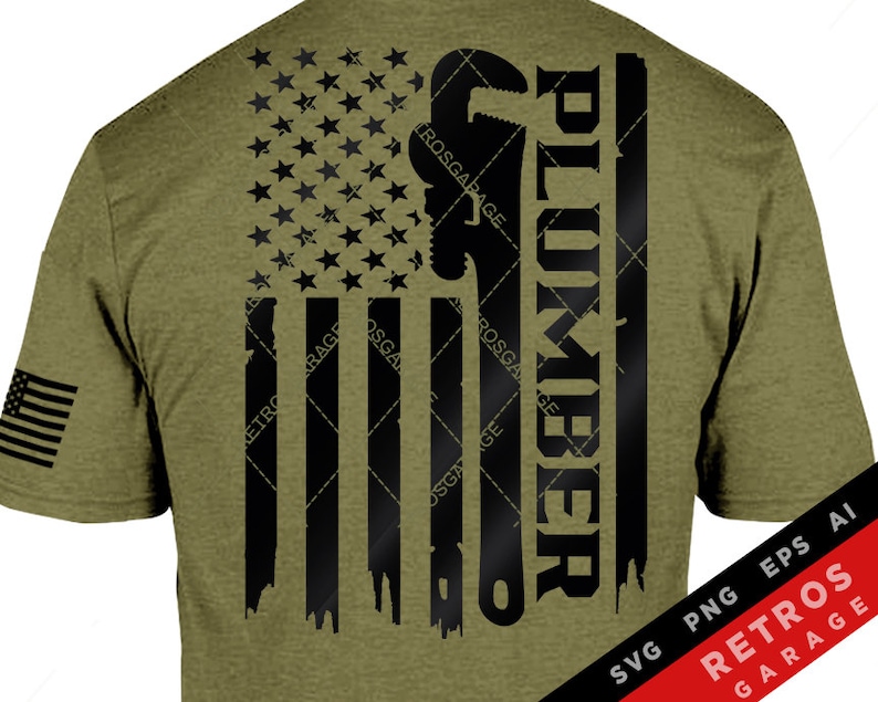 May include: Olive green t-shirt with a distressed American flag design incorporating a wrench and the word "PLUMBER" in black. A small American flag is on the sleeve. The design includes the text "RETROS GARAGE".