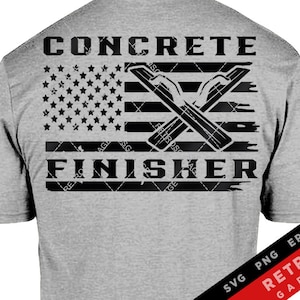 May include: A light gray t-shirt featuring a distressed American flag design with the words "CONCRETE FINISHER" in bold, black letters. The flag incorporates crossed concrete finishing tools. A smaller American flag is on the left sleeve.
