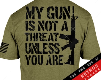 May include: A green t-shirt with the text "MY GUN IS NOT A THREAT UNLESS YOU ARE" in black lettering. The text is in a bold, blocky font. A silhouette of a rifle is to the right of the text. The text "SVG PNG EPS AI RETROS GARAGE" is in the bottom right corner of the image.