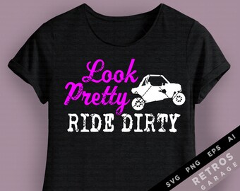 May include: Black t-shirt with pink text that reads "Look Pretty Ride Dirty". A white silhouette of a side-by-side vehicle is above the text.