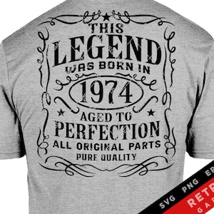 May include: A gray t-shirt with a black graphic design that says "This Legend Was Born In 1974 Aged To Perfection All Original Parts Pure Quality".