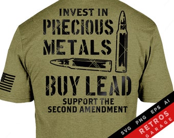 May include: A green t-shirt with a black graphic print that says "Invest in Precious Metals Buy Lead Support the Second Amendment". The graphic also includes a bullet and a bullet casing.