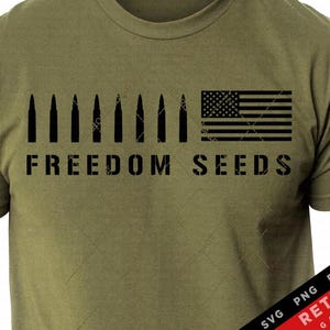 May include: A green t-shirt with a black distressed graphic of an American flag and a row of bullets. The text "FREEDOM SEEDS" is below the graphic.