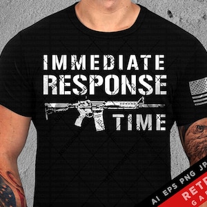 May include: A black t-shirt with a white graphic design that says "Immediate Response Time" with a stylized image of a rifle. The shirt has a distressed look and a small American flag on the right sleeve.
