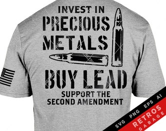 May include: A gray t-shirt with black text that reads "Invest in Precious Metals Buy Lead Support the Second Amendment". The text is stylized to look like bullet holes. There is a bullet graphic on the right side of the text.