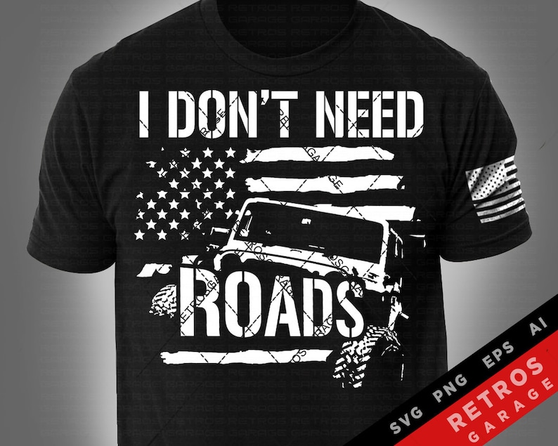 May include: Black and white graphic design of a Jeep driving off-road with an American flag background. The text "I don't need roads" is written above the Jeep. The design is on a black t-shirt.