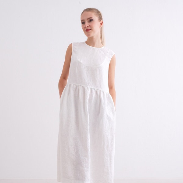 Robe midi en lin. Robe mi-longue pour femme en lin avec poches et fermeture boutonnée dans le dos.