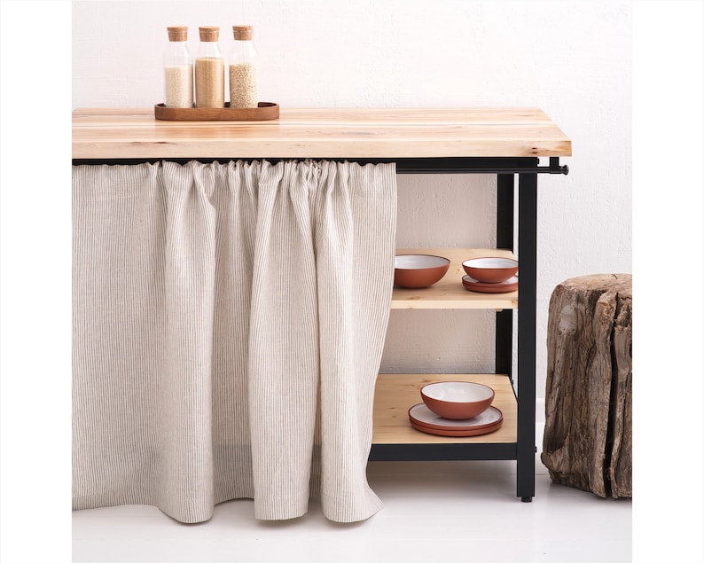 A minimalist kitchen setup with stone washed linen curtains in a natural hue, providing a farmhouse feel, suitable for use as cafe curtains or custom-sized window valances.