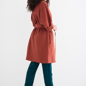 Rear view of a woman in a "Comfortable and Stylish Plus Size Linen Maxi Coat with Pockets," a versatile, everyday washed linen duster.