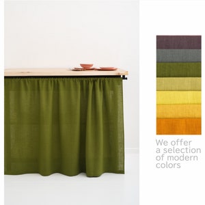 Moss green stone washed linen privacy curtain displayed with a wooden shelf and a color swatch palette.