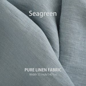 A textured seagreen pure linen fabric draped elegantly, with "Seagreen" and "PURE LINEN FABRIC, Width 55 inch/140 cm" text showcasing its color and size.