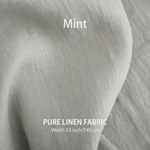 Mint-colored pure linen fabric, showcasing the soft texture and high-quality European woven flax, available for purchase by the yard.