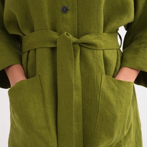 Close-up of a "Comfortable and Stylish Plus Size Linen Maxi Coat with Pockets," a green versatile washed linen duster tied at the waist.